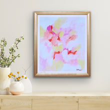 Load image into Gallery viewer, Pink abstract art print on paper. This colorful abstract has shades of pink, peach, yellow, orange, white. It has a white border and is signed by the artist. It measures 20 x 24 and is displayed in a frame over a table with 3 vases of flowers.
