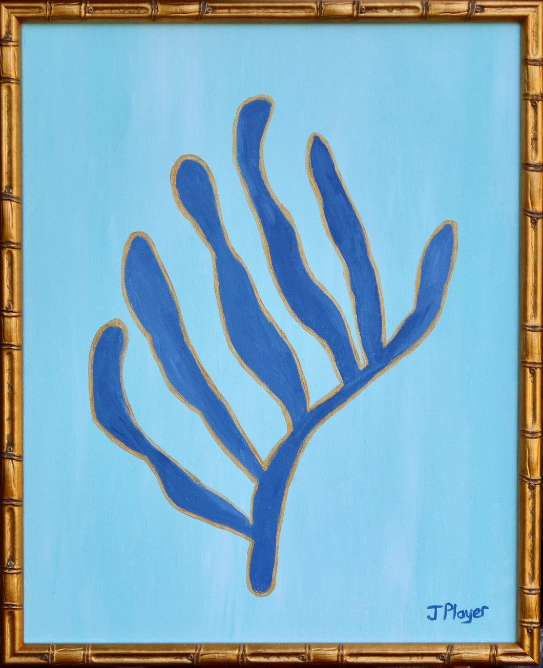 Navy Blue seaweed shape outlined in gold on light blue background. This preppy vertical painting is in a gold bamboo frame. Signed by the artist on the front. based on Matisse's famous cut outs.