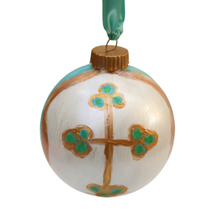 Load image into Gallery viewer, An original hand painted cross on a white ornament. The gold cross has dots of green and blue on the ends. The abstract design features blues, white, green and gold with a gold top and a green ribbon.
