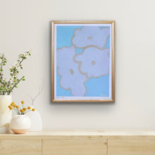 Load image into Gallery viewer, Blue Floral Print on Paper. This modern bold floral print has shades of blue, white and tan. The print has a white border and is signed by the artist. It is displayed in a frame over a table with 3 vases of flowers.
