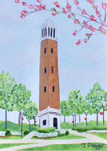 Load image into Gallery viewer, Denny Chimes Acrylic Block Art. This Alabama Crimson Tide free standing acrylic block art is vertical and features the famous Bell Tower landmark that is in The Quad at The University of Alabama. This is a print on an acrylic block of a bell tower with flowering trees and plants. Roll Tide!
