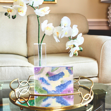 Load image into Gallery viewer, A small colorful abstract paining on paper in an acrylic frame. This painting has shades of blue, green, purple, yellow and white. It is initialed by the artist on the front.