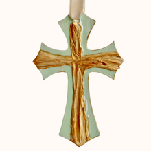 Load image into Gallery viewer, The Green Cross Ornament is an original hand painted work of art. There us a textured gold on a green background also in the shape of a cross. The sides are also painted gold.It has a cream riboon.