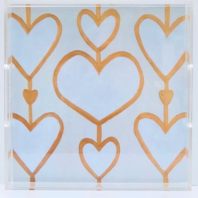 The Heartstring Acrylic Tray is square and has clear acrylic sides with two handles. It has a white and gold heart background on the bottom. Heart art tray.