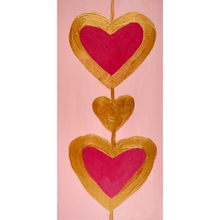 Load image into Gallery viewer, Heart Art. A 2. 5 x 7.5 vertical free standing acrylic block with a pink background and two red hearts outlined in gold connected by a gold line.