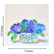 Load image into Gallery viewer, Freestanding hydrangeas acrylic art block featuring blue and purple floral artwork with green leaves in a decorative cachepot.
