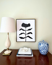 Load image into Gallery viewer, original Framed black and white abstract floral art on a wall above a wood chest with a curry and company lamp, chanel books. Modern luxury art.
