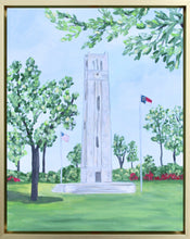Load image into Gallery viewer, NC State University Bell Tower is an original modern impressionistic painting on a gallery wrapped canvas. This vertical painting measures 11 x 14 inches and comes in a gold float frame. It has colors of green, blue, yellow, white, gray. It is a springtime painting with flowering trees and azaleas. There is a US flag on one side and a NC State flag on the other.
