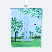 Load image into Gallery viewer, NC State Bell Tower Christmas ornament made from Jeanne Playerâs original artwork, lightweight acrylic with double-sided design and satin ribbon. This ornament has shades of blue, gray, white and green and red. Wolfpack ornament.
