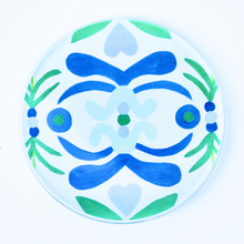 Load image into Gallery viewer, Acyrlic Coasters with Nantucket pattern. Original art transfered on to a 4 inch round acrylic coaster with a cork bottom. The coaster has shades of blue, green, light blue on a white background. 
