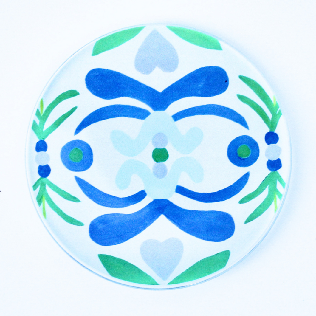 Acyrlic Coasters with Nantucket pattern. Original art transfered on to a 4 inch round acrylic coaster with a cork bottom. The coaster has shades of blue, green, light blue on a white background. 