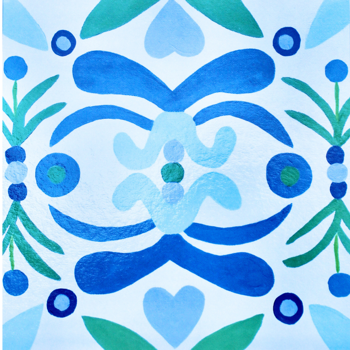 A colorful coastal inspired tray liner placemat. This square placemat has shades of blue, green on a white background. 