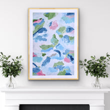 Load image into Gallery viewer, "Coastal-inspired abstract art print titled 'New Beginnings' in soft shades of white, blue, green, pink, and gray, available in multiple sizes and shown displayed in a frame over a fireplace.