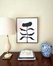 Load image into Gallery viewer, Minimalist modern floral painting with a black flower on a white background in a black and gold float frame.