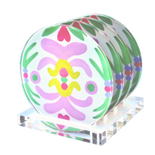 Load image into Gallery viewer, A colorful and preppy coaster set. The Palm Beach coasters come in a set of four on a stand. They are round acrylic coasters. They have a tropical pattern in shades of green, purple, fuchsia, yellow and pink on a white background. The stand is clear acrylic.