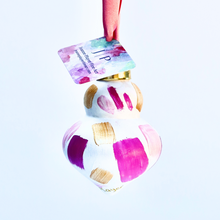 Load image into Gallery viewer, Pink Confetti ornament is a colorful original artwork on a ceramic ornament. This abstract ornament has shades of pink and gold on a white background and looks like confetti. The ornament has a gold top and pink ribbon. It has a pink ribbon.