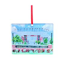 Load image into Gallery viewer, A Chrismtas ornament for Alabama fans. This is the new Saban Field at Bryant Denny Stadium Christmas ornament. It shows the iconic football stadium at the University of Alabama.  It is an original work of art printed on acrylic and has a red ribbon. Roll Tide!