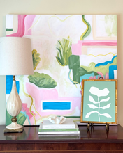 Load image into Gallery viewer, Palm Beach styled interior with a colorful abstract painting on canvas. A sage green and white modern botanical painting and green and white books with a ruffled bowl.