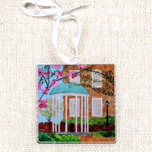 Load image into Gallery viewer, UNC Old Well acrylic ornament featuring Jeanne Player’s original artwork – University of North Carolina Chapel Hill holiday keepsake with satin ribbon. This is a square ornament. it is lightweight and features the Old Well on the campus of UNC. Go Tarheels.
