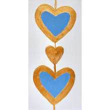 Load image into Gallery viewer, Two blue hearts outlined in gold with a gold heart between them. This original work of art is a shel sitter and has gold sides. The hearts are on a white background. Heart art painting.
