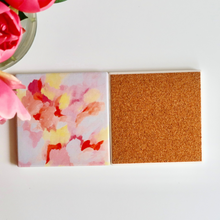 Load image into Gallery viewer, Pretty in Pink ceramic coaster displayed on a coffee table, adding colorful grandmillennial style and protecting furniture from drink rings.
Close-up of colorful ceramic drink coaster with abstract pink artwork and durable cork backing by Jeanne Player.
Decorative ceramic coaster set featuring feminine abstract artwork, ideal for hostess gifts, housewarming gifts, and colorful kitchens.