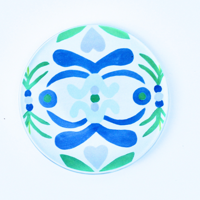 Acrylic Coasters with Nantucket pattern. Original art transferred on to a 4 inch round acrylic coaster with a cork bottom. The coaster has shades of blue, green, light blue on a white background.
