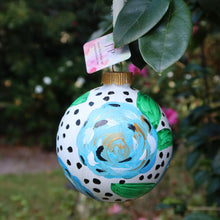 Load image into Gallery viewer, Hand-painted blue Christmas ornament displayed with cream silk ribbon and original floral artwork.
Blue and white floral holiday ornament with metallic gold accents, perfect for elegant Christmas decorating.
Original floral Christmas ornament featuring expressive blue blossoms and green leaves on a modern dotted background.