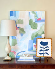 Load image into Gallery viewer, A blue botanical silhouette original painting on canvas styled with larger art on a table.