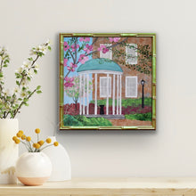 Load image into Gallery viewer, UNC Old Well giclée print featuring the iconic University of North Carolina Chapel Hill landmark in vibrant Carolina blue tones, whte, pink, gray, green, red, black and brown.