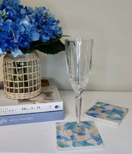 Load image into Gallery viewer, Coastal ceramic stone coasters featuring original abstract artwork by Jeanne Player Fine Art, inspired by ocean-tumbled sea glass with blue, green, coral, and white tones.