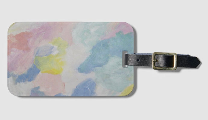 A colorful luggage or diaper bag tag with an abstract design. This  tag has shades of blue, green, yellow, pink and white and comes with a leather strap to attach to your luggage or bag.