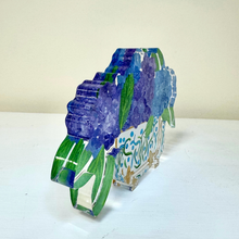 Load image into Gallery viewer, Whimsical floral acrylic shelf sitter with vibrant blue and purple hydrangeas and soft painterly details in blue, green, white, and gold.
Decorative acrylic art block featuring hydrangea flowers and lush greenery designed for bookshelves, desks, and tabletop styling.

