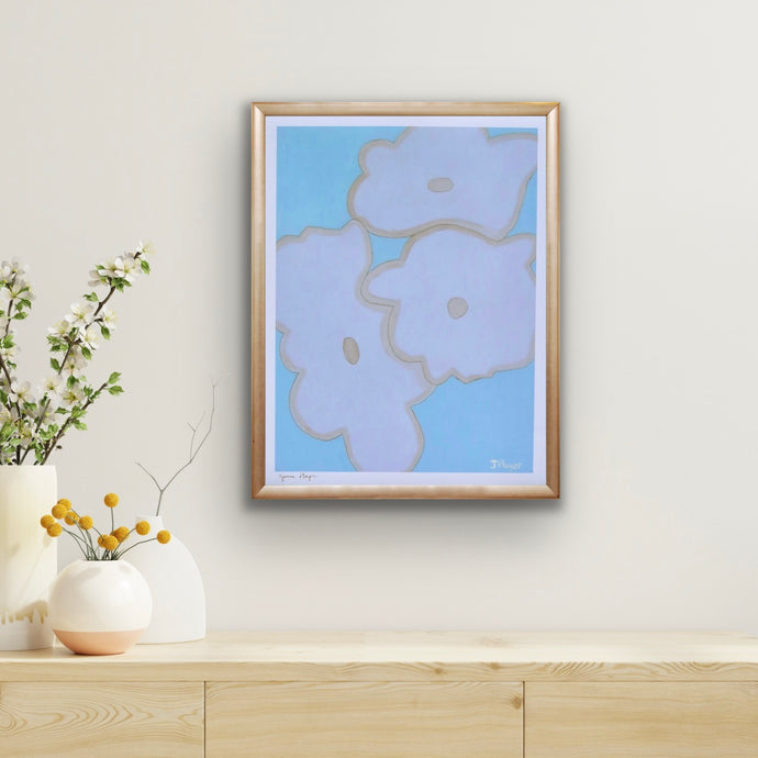 Blue Floral Print on Paper. This modern bold floral print has shades of blue, white and tan. The print has a white border and is signed by the artist. It is displayed in a frame over a table with 3 vases of flowers.