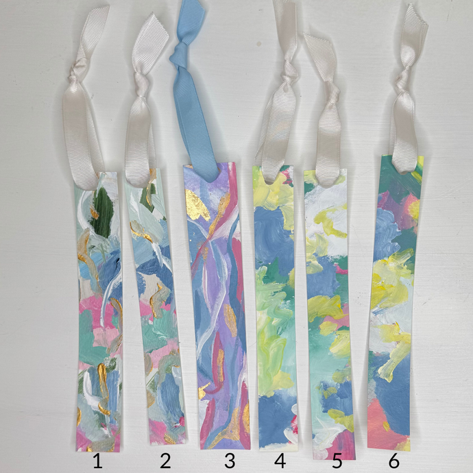 Hand-painted colorful bookmark with shades of blue, pink, green, yellow, and gold on heavyweight watercolor paper. Handmade and handcrafted bookmark tied with ribbon, approx. 8 x 1 inches, signed on the back by artist Jeann Player – perfect teacher or reader gift.