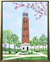 Load image into Gallery viewer, The University of Alabama&#39;s Belltower, Denny Chimes. This is an abstract landscape painting of the Belltower.  The belltower  has a brick center and is white at the top and bottom. It is pictured on The Quad with sidewalks, flowers, trees, shrubbery and blooming tree branches. You also see 6 lightpost. 
