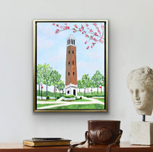 Load image into Gallery viewer, Original acrylic painting of Denny Chimes at the University of Alabama featuring the iconic brick bell tower, blooming pink dogwood branches, and lush campus greenery in a gold float frame.
