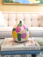 Load image into Gallery viewer, This one-of-a-kind hand-painted pumpkin brings a playful pop of color to your fall décor! 🎃 Styled here on a coffee table, the pumpkin’s garden-inspired shades of green, yellow, white, pink, and peach create a fresh and whimsical twist on traditional autumn decorations. Perfect as a tabletop centerpiece, mantel accent, or shelf display, this lightweight foam pumpkin adds charm and personality to any room. Each pumpkin is an original work of art by Jeanne Player.
