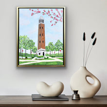 Load image into Gallery viewer, Officially licensed Crimson Tide artwork of Denny Chimes surrounded by blooming dogwoods and green trees painted on gallery wrapped canvas and framed in gold.
