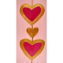 Load image into Gallery viewer, Heart Art. A 2. 5 x 7.5 vertical free standing acrylic block with a pink background and two red hearts outlined in gold connected by a gold line.

