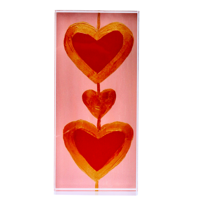 Free Standing Acrylic block with 2 red hearts  and a gold heart in between. They are outlined in gold and have a gold line connecting them.