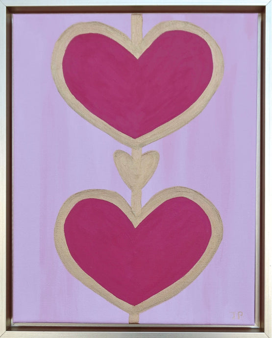 Heart Art on Canvas with Two Red Hearts on the top and bottom and a smaller gold heart in between them. The hearts are outlined in gold on a pink background. Vertical Art on Canvas measuring 11 x 14 inches in a gold float frame. This is a colorful, preppy piece of pop art.