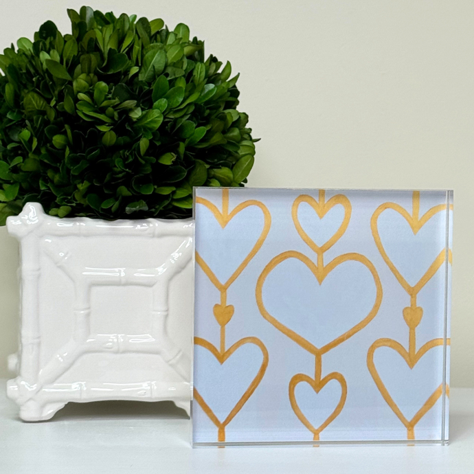 Heartstrings XII acrylic block art featuring white and gold heart design by Jeanne Player, displayed on a shelf. This freestanding acrylic block is square and has a three dimensional feel. It would be the perfect gift for friends, family and loved ones.