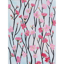 Load image into Gallery viewer, The Cherry Blossom Art Print is a giclee print printed on paper. It is shown displayed in a black frame over a day bed. This print has shades of pink and red blooms on a dark gray and black branches. The background is light blue. It has a white border. This is an abstract floral print.
