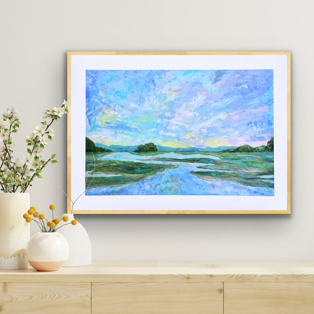 Colorful marsh art print.  This low country inspired artwork has shades of blue, green, yellow, pink, white, tan, purple and brown. It shows a sunset over a marsh with the colors reflecting in the sky.  This print brings memories of Charleston, Wilmington, Savannah as well as other coastal areas.