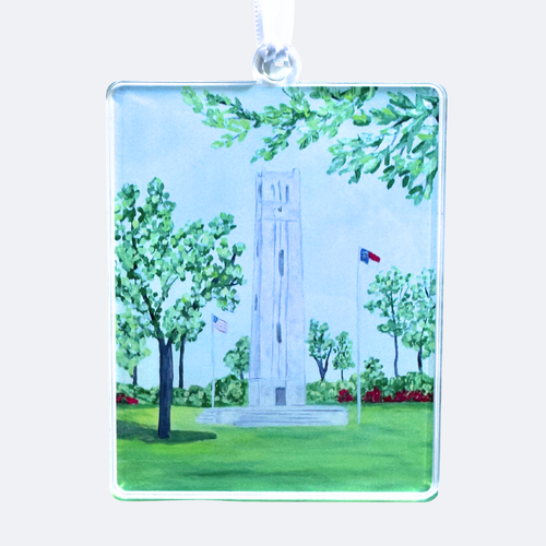 NC State Bell Tower Christmas ornament made from Jeanne Player’s original artwork, lightweight acrylic with double-sided design and satin ribbon. This ornament has shades of blue, gray, white and green and red. Wolfpack ornament.