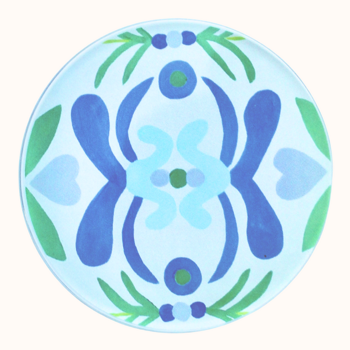 The Nantucket Coaster is a round blue, green and white acrylic coaster. It has a colorful coastal and fun design. 