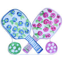 Load image into Gallery viewer, The Pickleball Acrylic block is a free standing shelf sitter.  This colorful and whimsical set of pickleball paddles have pink and blue flowers with green leaves, striped handle and a pink and green pickleball. It is preppy and colorful.
