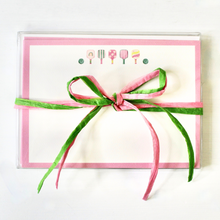 Load image into Gallery viewer, This is a cute and preppy stationery set of 10 flat note cards designed by Jeanne Player Fine Art. These cards have five colorful pickleball paddles and two green balls. The border is outlined in pink. The set has cute packaging with a pink and green raffia bow.
