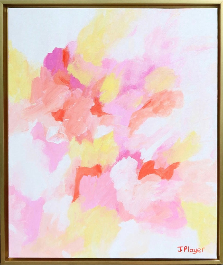 A colorful abstract painting on canvas. This artwork has shades of pink, fuchsia, yellow, coral, orange and white. It is a vertical painting in a gold float frame.