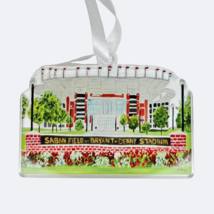A Saban Field at Bryant Denny Stadium Christmas Ornament featuring the iconic football stadium at the University of Alabama. This is a cut out shape of acrylic. It is shatterproof. it has shades of white, black, gray, gold, red and green.